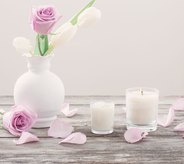 flowers in vase with scented candle
