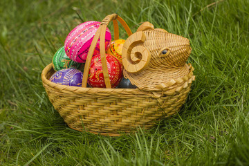 Easter Eggs in the basket of lamp shape on grass