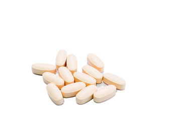 Heap of orange round medicine tablet pills