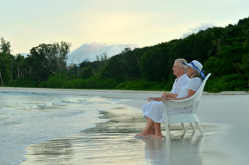 Elderly couple sitting on the shore