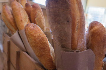 Baguettes, fresh loaves of bread stacked in bags