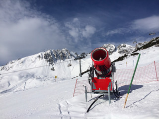 Fototapeta na wymiar Modern red snow cannon in sunny day