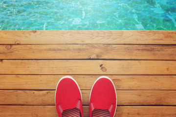 Canvas shoes on wooden deck. View from above