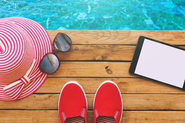 Summer holiday vacation essential objects on wooden deck