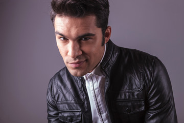 smiling young fashion man looking at the camera.