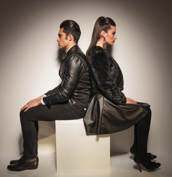 young fashion couple sitting on a white table