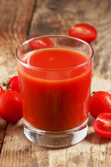 Fresh tomato juice and tomatoes on the table, selective focus