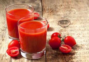 Fresh tomato juice and tomatoes on the table, selective focus