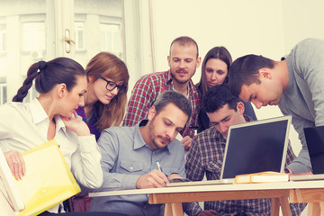 Young group of people discussing business plans.