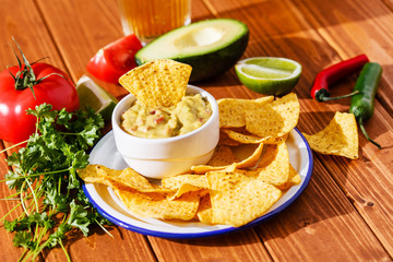 Guacamole with avocado, lime, tomato, and cilantro