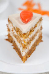 Tasty piece of homemade carrot easter cake with little orange