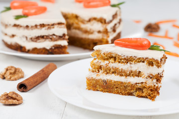 Delicious slice of carrot sponge cake with icing cream and