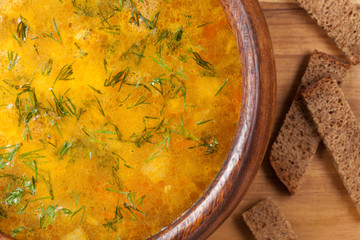 Chicken noodle healthy broth soup with croutons close up