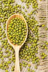 Healthy nutrition green raw organic mung beans in wooden spoon