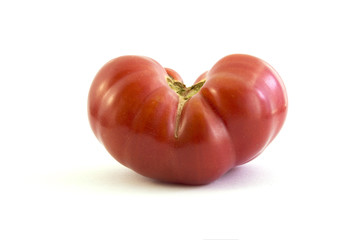 tomato in heart shape on white background