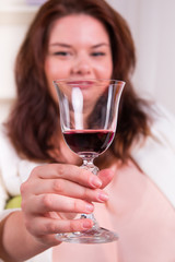 Woman holding a glass of red wine