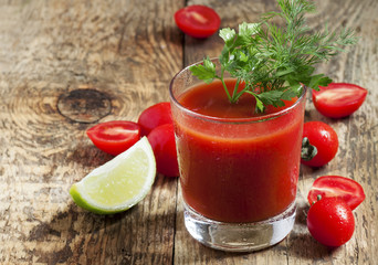 Red cocktail with tomato juice, lime and salt, selective focus