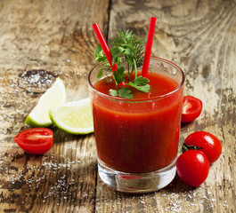 Red cocktail with tomato juice, lime and salt, selective focus