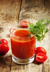 Fresh tomato juice with herbs and tomatoes, selective focus