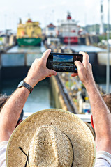 Tourists shoot a photograph the Panama Canal