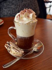 Delicious Viennese coffee in glass cup with whipped cream