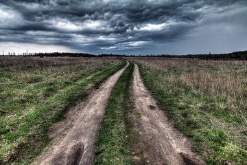 Fototapeta na wymiar dirt road going into the eye of the storm.