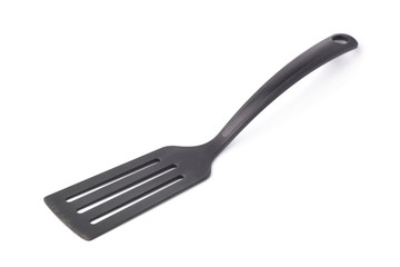 Used black plastic spatula isolated
