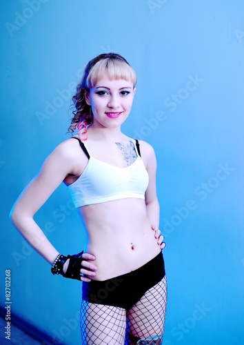 Young Beautiful Sexy Girl In Undershirt And Shorts Near Wall Young Beautiful Sexy Girl In Undershirt And Shorts Near Wall