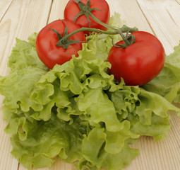 Tomatoes and lettuce on the wooden table