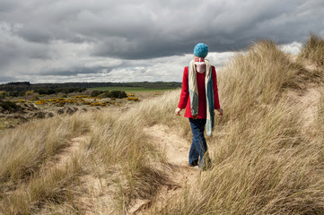 Picture of a woman standing in the sand dunes