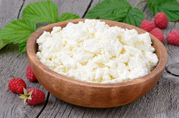 Curd cheese in wooden bowl