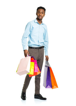 African american man holding shopping bags on white. Holidays co