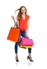 Happy lovely woman with shopping bags over white