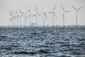 wind turbines power generator farm along coast sea