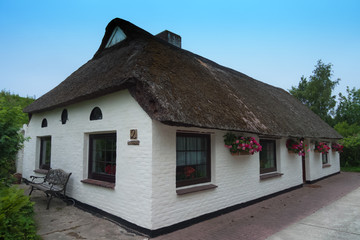 Fototapeta na wymiar Architecture in North Frisia old white house with thatched roof