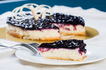 a mouthful of blueberry cheesecake