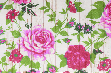  rose vintage from fabric on white wooden background.