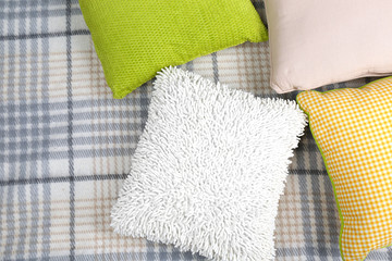 Decorative pillows on plaid close up