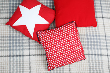 Obraz premium Decorative pillows on plaid close up