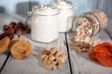 Healthy breakfast with dried fruits and nuts on color wooden background