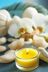 Still life with beautiful blooming orchid flower, spa treatment on wooden table, on bright background