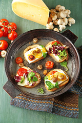 Tasty sandwiches on old pan, on wooden table