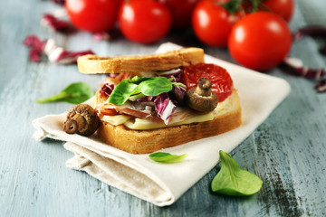 Tasty sandwich on wooden table, close up