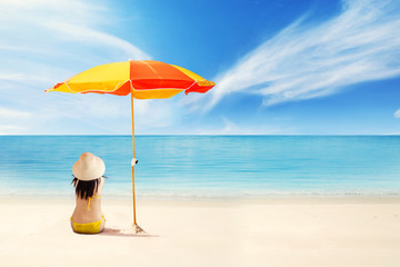 Woman sitting under umbrella shade