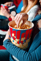 Woman eating popcorn in cinema