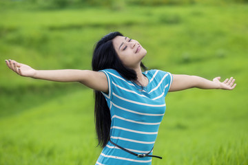 Pretty woman breathe fresh air at field