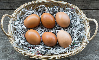 A few eggs in a wooden basket