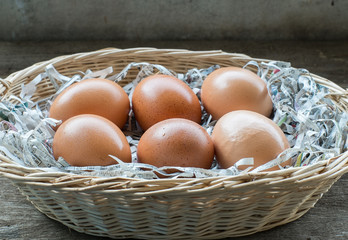 A few eggs in a wooden basket