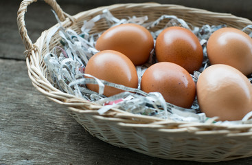 A few eggs in a wooden basket