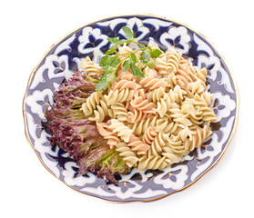 Penne pasta with sauce, cheese and basil, selective focus